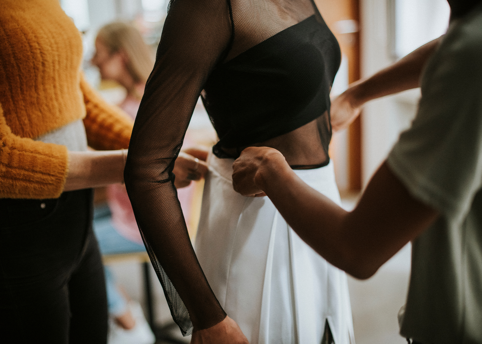 A model being fitted for a skirt